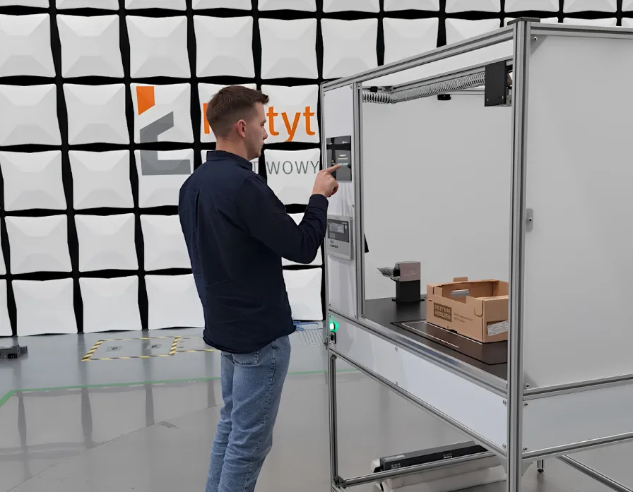 An operator confirming a scan on the station's touch panel.